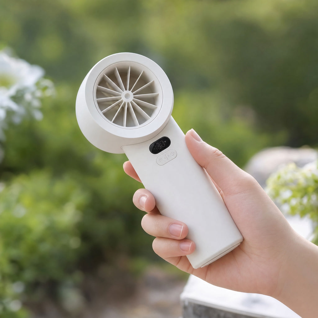 Handheld fan held in hand outdoors